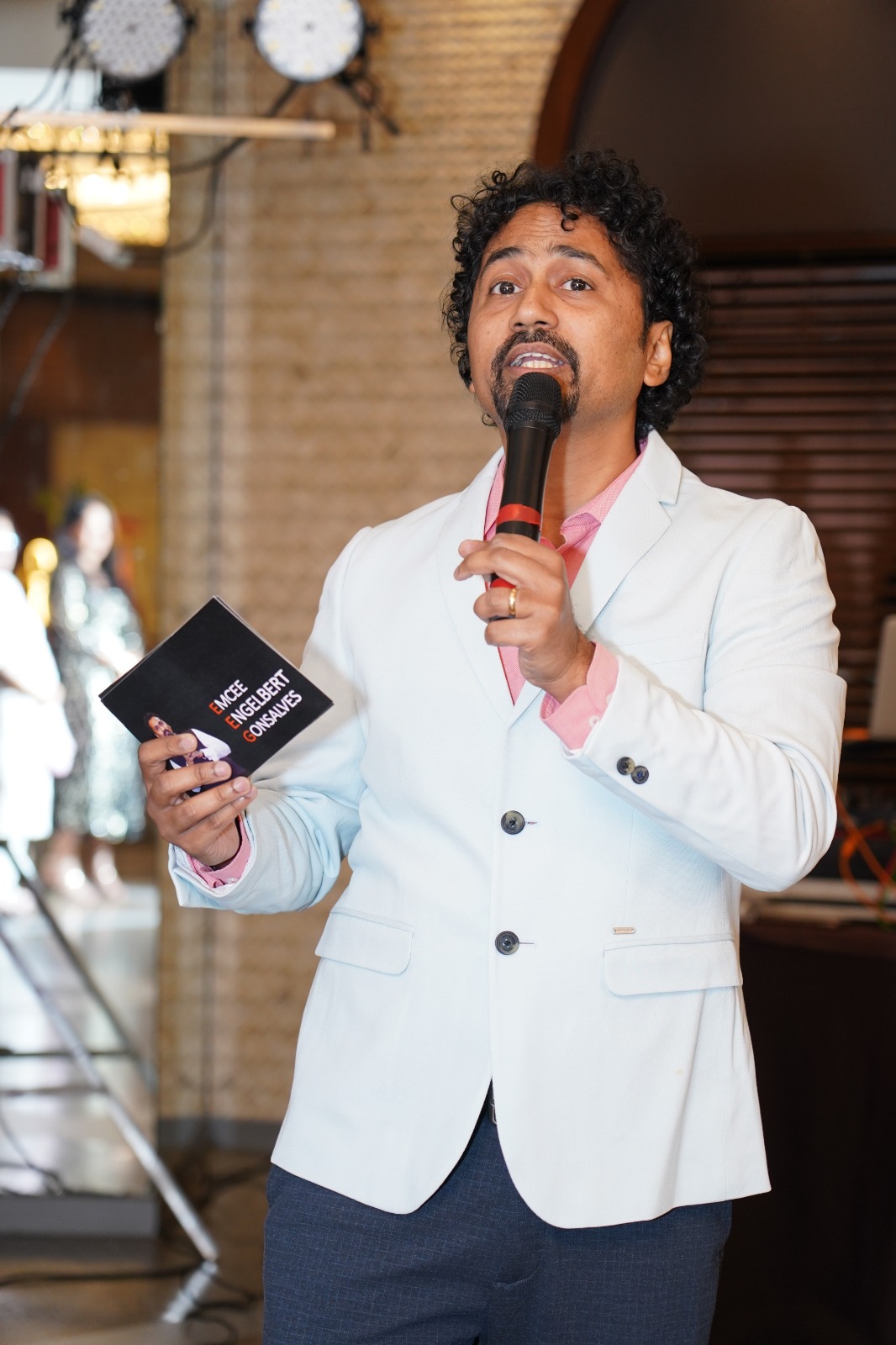 Emcee with microphone and card
